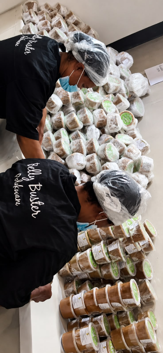 Belly Buster team hand-packing tubs in branded uniforms